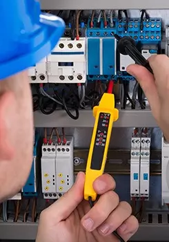 electrician inspecting fuse board